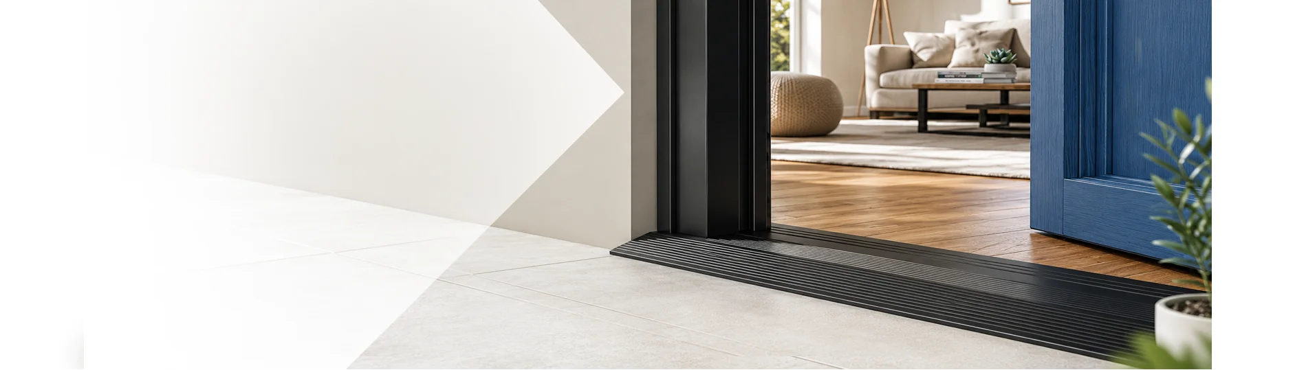 Black low-profile door threshold ramp with safety anti-slip ridges installed under an open blue sliding door, transitioning smoothly into a bright, modern living room.